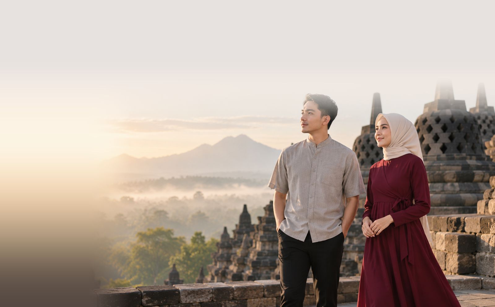 Indonesian man and woman in modest apparel at Borobudur at sunrise